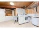 Functional laundry room with washer, dryer, and built-in shelving at 6341 Biggs St, Englewood, FL 34224