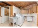 Laundry room with washer, dryer, utility sink, and extra storage at 6341 Biggs St, Englewood, FL 34224