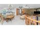 Open-concept living area with a stone fireplace, a dining area, and kitchen, offering a blend of comfort and style at 6341 Biggs St, Englewood, FL 34224