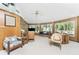 Living room with stone wall, comfy seating, and large windows at 6341 Biggs St, Englewood, FL 34224