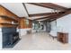 Spacious living room featuring exposed beams, tiled floors, and comfortable seating at 6341 Biggs St, Englewood, FL 34224