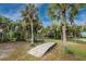 Wooden pathway leading to a charming waterfront home at 6341 Biggs St, Englewood, FL 34224