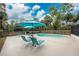 Relaxing poolside space with lounge chairs and umbrellas at 6341 Biggs St, Englewood, FL 34224