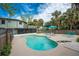 Kidney-shaped pool with lounge chairs and patio furniture in a tropical backyard setting at 6341 Biggs St, Englewood, FL 34224