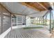 Covered porch with a view of the tropical landscaping at 6341 Biggs St, Englewood, FL 34224