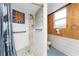 Walk-in shower with tiled surround, glass blocks and handheld sprayer at 6341 Biggs St, Englewood, FL 34224