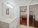Bright bathroom with a vanity and view of bedroom at 66 Boundary Blvd # 282, Rotonda West, FL 33947