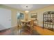 Bright dining area with round table, four chairs, and geometric floor at 66 Boundary Blvd # 282, Rotonda West, FL 33947