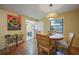 Dining area with table, chairs, and view into kitchen at 66 Boundary Blvd # 282, Rotonda West, FL 33947