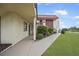Exterior view of condo building, showing walkway, landscaping, and canal view at 66 Boundary Blvd # 282, Rotonda West, FL 33947
