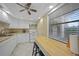 White kitchen with butcher block island and window overlooking trees at 66 Boundary Blvd # 282, Rotonda West, FL 33947