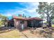 Backyard view of house with screened porch at 660 S Broadway St, Englewood, FL 34223