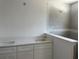 Bathroom featuring double sinks, white cabinetry, and separate shower area at 7351 Lighthouse St, Englewood, FL 34224