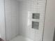 New white tile in the bathroom with built-in shower niches at 7351 Lighthouse St, Englewood, FL 34224