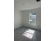 Bright bedroom features a large window and modern tile flooring at 7351 Lighthouse St, Englewood, FL 34224