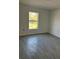 Bright bedroom features tile floors and a large window offering outdoor views at 7351 Lighthouse St, Englewood, FL 34224