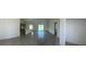 Spacious living room with tiled floors leading to the kitchen and sliding glass door entrance at 7351 Lighthouse St, Englewood, FL 34224