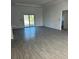 Bright open-plan living area with neutral color palette and sliding doors to the outside at 7351 Lighthouse St, Englewood, FL 34224