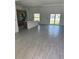 Bright, open-concept living room and kitchen with tile flooring and sliding glass doors at 7351 Lighthouse St, Englewood, FL 34224
