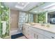 Bathroom with a double vanity, walk-in shower, and tropical wallpaper at 7482 Palm Island Dr # 2511, Placida, FL 33946