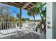 Relaxing outdoor deck with white chairs and table, overlooking lush tropical foliage at 7482 Palm Island Dr # 2511, Placida, FL 33946