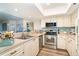 Modern kitchen with stainless steel appliances and light wood flooring at 7482 Palm Island Dr # 2511, Placida, FL 33946