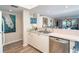 Open kitchen with a breakfast bar, stainless steel appliances, and ocean views at 7482 Palm Island Dr # 2511, Placida, FL 33946