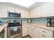 Updated kitchen with stainless steel appliances and white shaker cabinets at 7482 Palm Island Dr # 2511, Placida, FL 33946