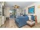 Living area features a comfy sectional sofa and access to balcony at 7482 Palm Island Dr # 2511, Placida, FL 33946