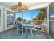 Peaceful screened balcony with table and chairs, offering an ocean view at 7482 Palm Island Dr # 2511, Placida, FL 33946