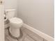 A view of a toilet in a minimalist bathroom with tile flooring at 8198 Clyde Cir, Port Charlotte, FL 33981