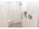 Modern shower with tiled walls, a built-in bench, and dual shower heads at 8198 Clyde Cir, Port Charlotte, FL 33981