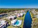 Aerial view of the community with a pool alongside a canal at 84 Boundary Blvd # 165, Rotonda West, FL 33947