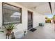 Balcony view of condo with plants, seating, and screened front door at 84 Boundary Blvd # 165, Rotonda West, FL 33947