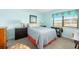 Serene bedroom with light blue walls, a comfortable bed, and a window at 84 Boundary Blvd # 165, Rotonda West, FL 33947