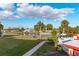 View of the community canal, lush green space, and waterfront deck at 84 Boundary Blvd # 165, Rotonda West, FL 33947