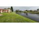 View of a canal with lush grass and condo buildings at 84 Boundary Blvd # 165, Rotonda West, FL 33947
