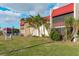 Exterior view of the Riverhouse condo building and lush landscaping at 84 Boundary Blvd # 165, Rotonda West, FL 33947