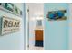 Hallway with beach-themed decor leading to the bathroom at 84 Boundary Blvd # 165, Rotonda West, FL 33947