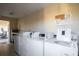 Shared laundry room with multiple washers and dryers at 84 Boundary Blvd # 165, Rotonda West, FL 33947