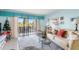 Bright living room with large windows and access to a private balcony at 84 Boundary Blvd # 165, Rotonda West, FL 33947