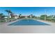 Tennis court with benches, a pond, and building in the background at 84 Boundary Blvd # 165, Rotonda West, FL 33947