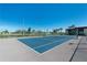 Community tennis court with fencing and surrounding green space at 84 Boundary Blvd # 165, Rotonda West, FL 33947