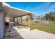 Covered patio overlooking backyard and canal at 9230 Griggs Rd, Englewood, FL 34224