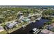 Bird's-eye view of a canal-front home and neighborhood at 9567 Honeymoon Dr, Port Charlotte, FL 33981