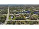 Aerial view showing a residential area with houses and lots near the water at 9567 Honeymoon Dr, Port Charlotte, FL 33981