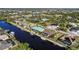 Aerial view of waterfront homes with private docks and lush landscaping at 9567 Honeymoon Dr, Port Charlotte, FL 33981