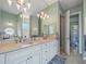 Elegant bathroom with double vanity and large mirror at 9567 Honeymoon Dr, Port Charlotte, FL 33981