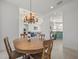 Bright dining room with kitchen view and wood table at 9567 Honeymoon Dr, Port Charlotte, FL 33981