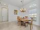 Charming dining room with wood table and chandelier at 9567 Honeymoon Dr, Port Charlotte, FL 33981